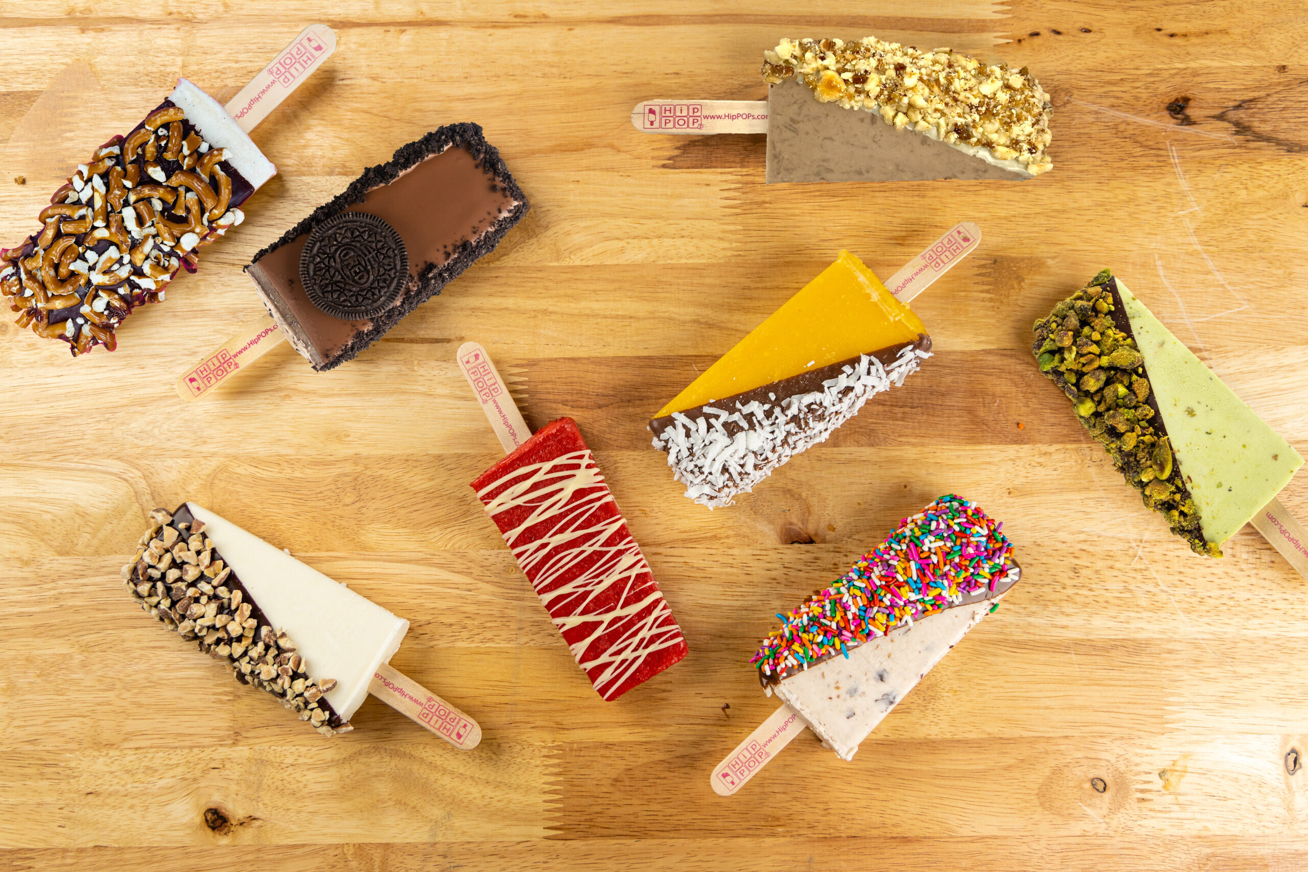 Colorful spread of HipPOPs POPs on a wood background